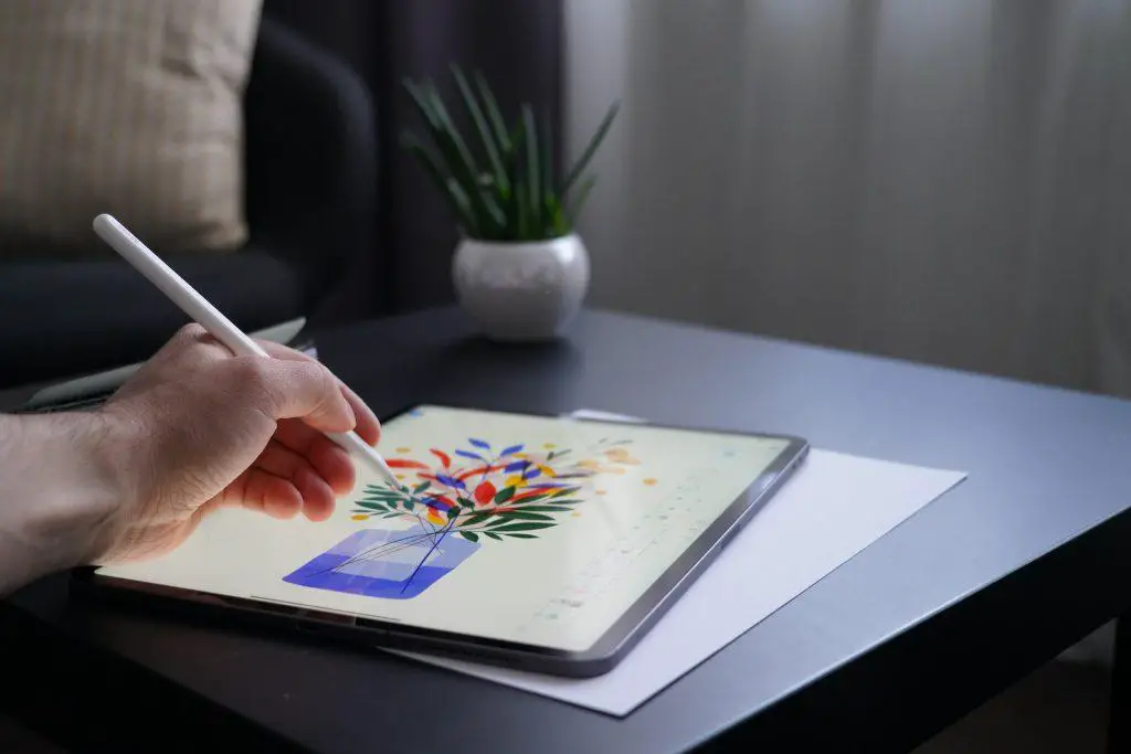 Illustrator making an illustration of a flower pot with ipad pro and apple pencil