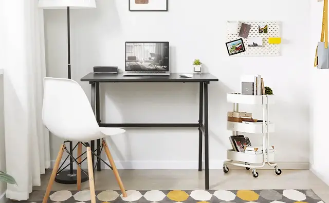 Minimal office design set up with small wooden table and plastic chair