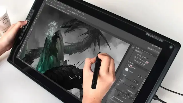 Person using Huion display tablet with pen stylus