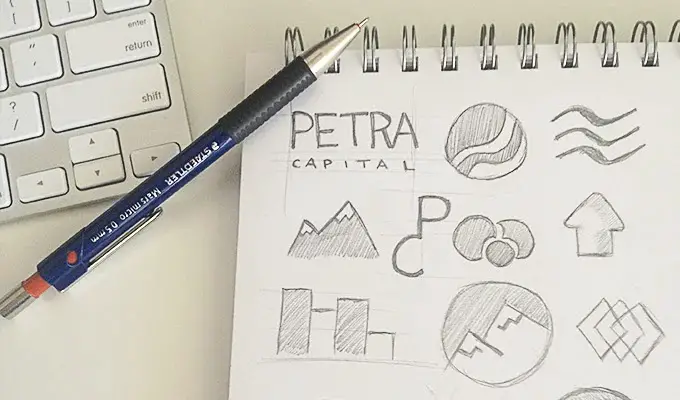 Sketchbook with various sketches of logo concepts